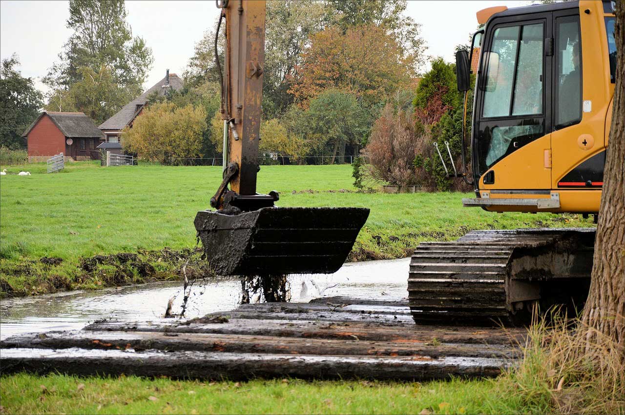 Image of an excavator ditch cleaning - Digger hire and excavator hire in Berkshire, Hampshire and Surrey - Ditching, drainage and flood minimisation - Berkshire, Hampshire and Surrey.