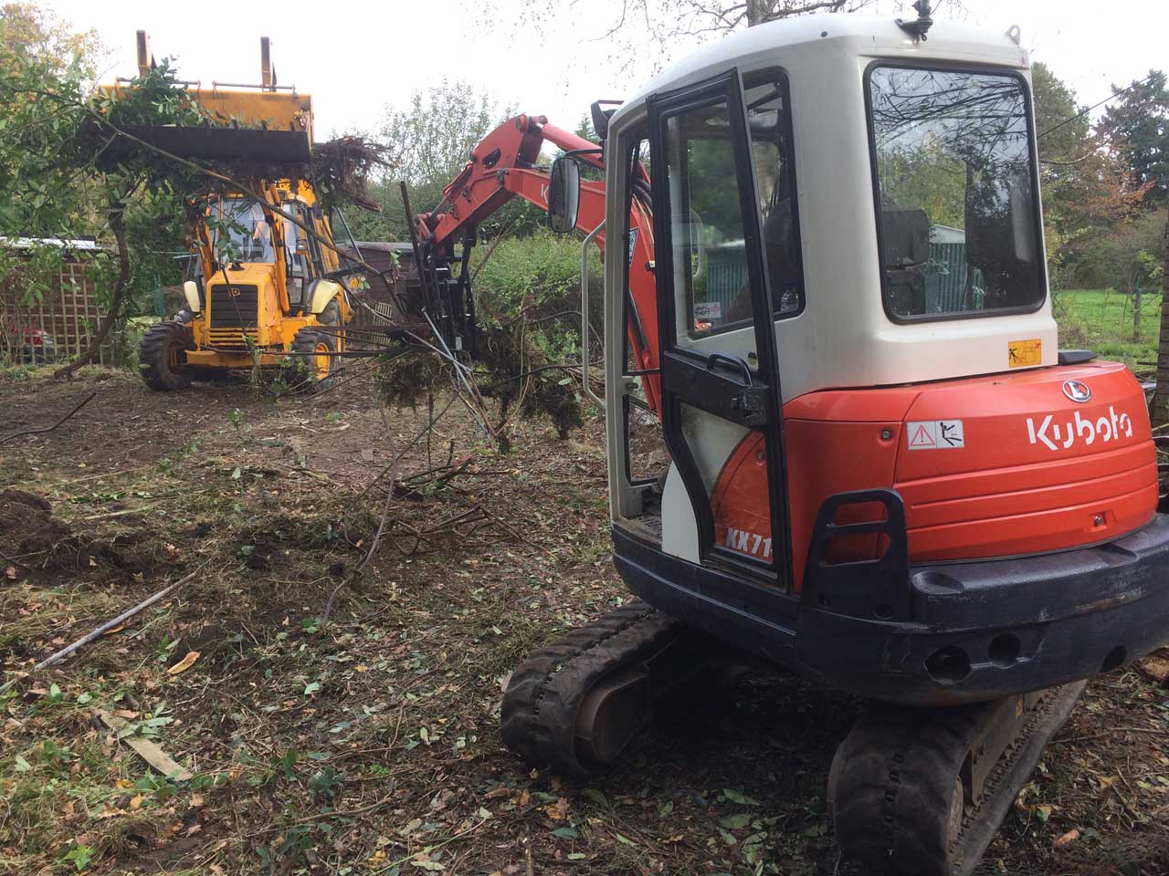 Image of a Kubota excavator and a JCB clearing land in Ascot, Berkshire - Land clearance in Ascot, Berkshire preparing for seeding - land clearing by kubota and JCB in Ascot, Berkshire - Let the digger do it!